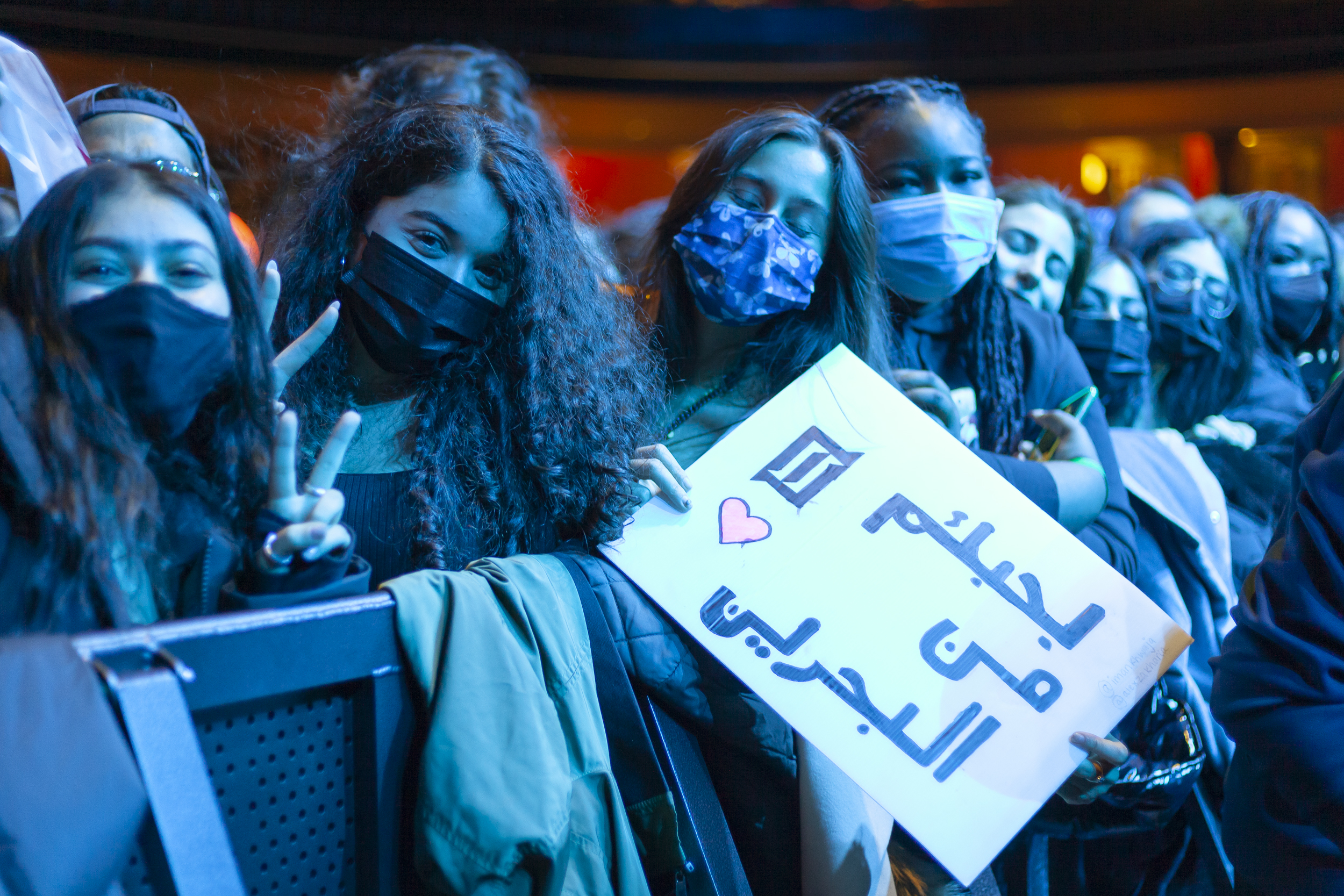 Fans at the Majid Jordan show holding a sign in the crowd
