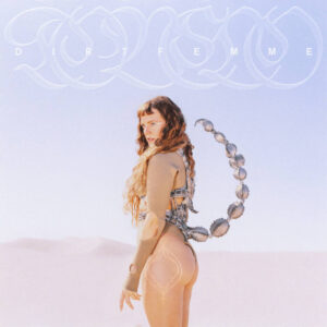 Album cover for Tove Lo's Dirt Femme. The artist stands with body facing left, while head is craned to look towards the camera, as if looking in the viewer's eyes. The album cover is mostly tan, silver, and white colors with Tove Lo only wearing a silver scorpion tail attached to a tan body suit. They stand amidst and arid desert.